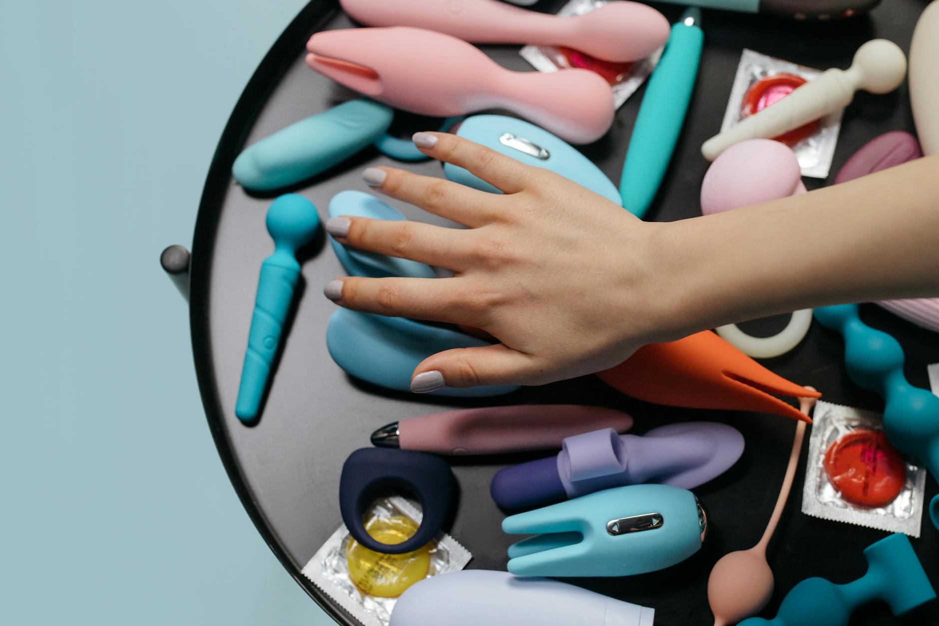 Hands holding a sleek vibrator, symbolizing intimate reconnection and reclaimed pleasure