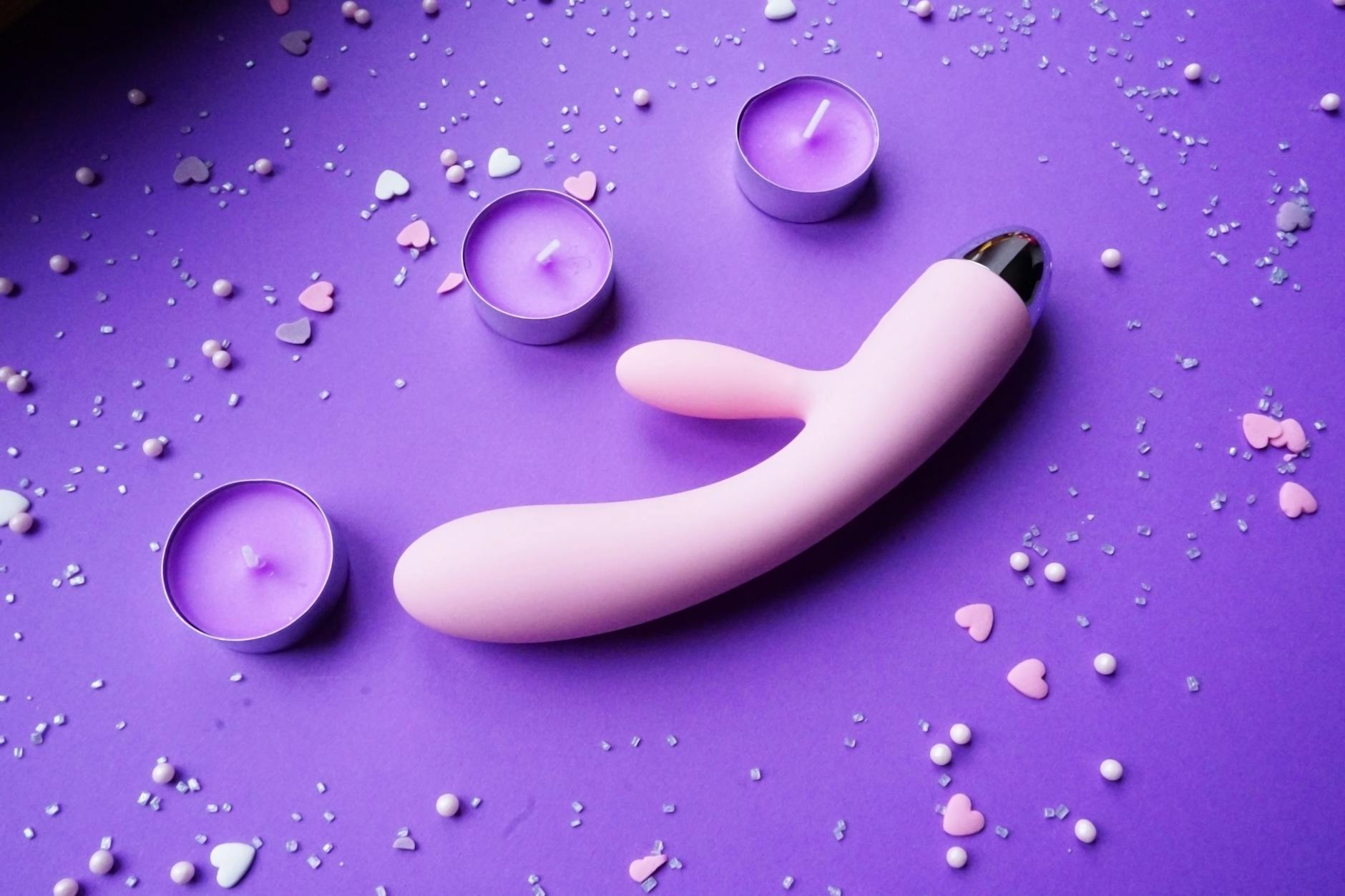 Woman holding colorful silicone vibrators, representing different tools for pleasure